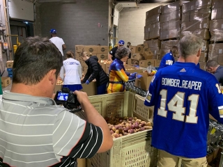 On site at @peakofthemarket telling the story of their community donation program. 🏈 💪🏽 🥔 🎥